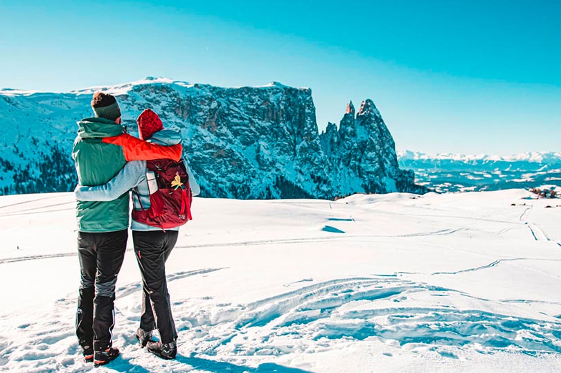 Una veduta del panorama invernale delle montagne di Alpe di Siusi con due sciatori